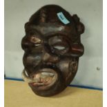 A South East Nigerian painted grotesque face mask from the Ibibio tribe, worn by members of the Ekpo