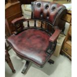 A red leather button back desk chair with studded decoration