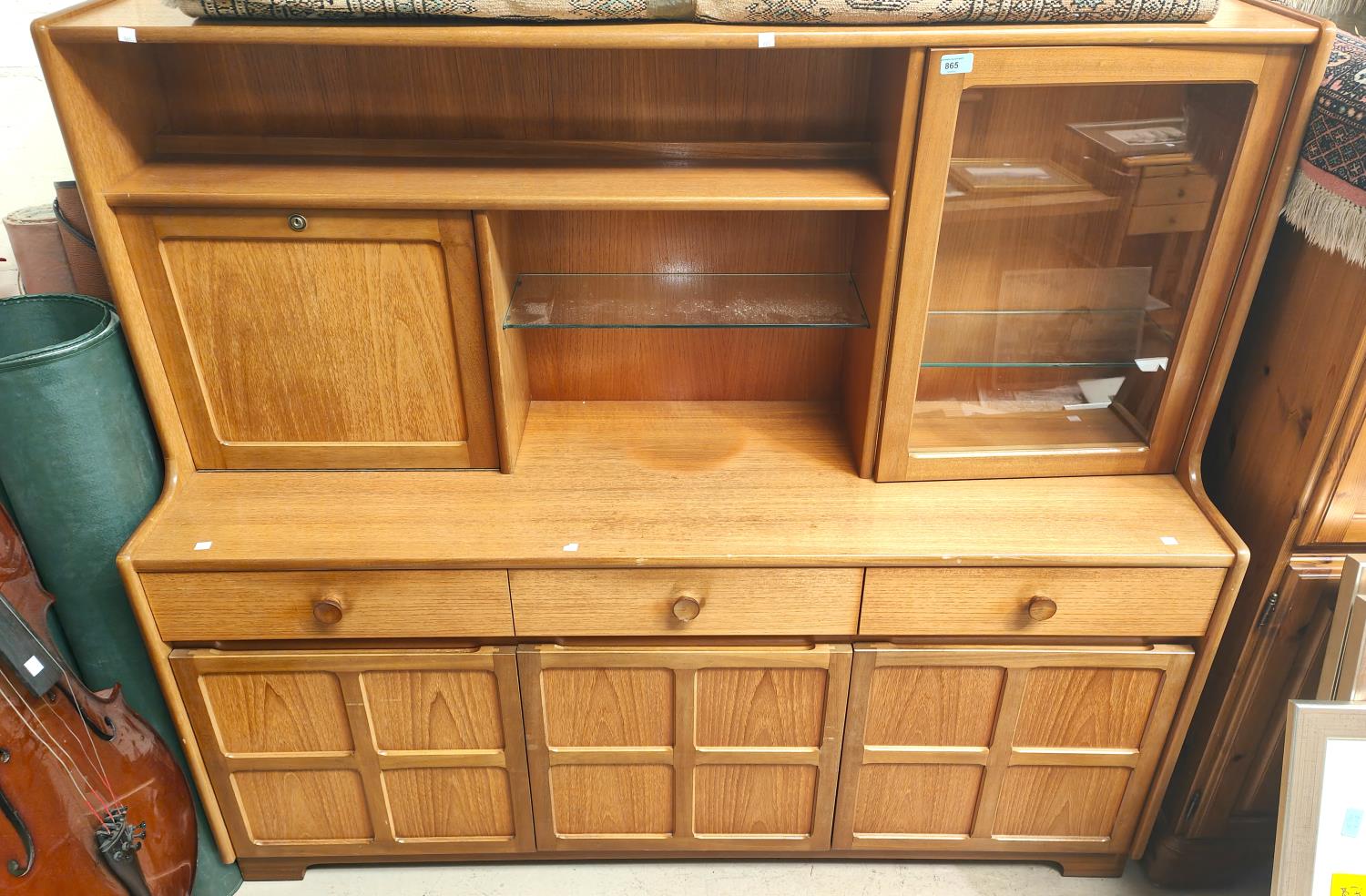 A mid 20th century teak high back sideboard with 3 drawers and cupboards below, fall front