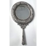 A white metal hand mirror decorated with grapes vines etc
