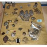 A selection of military badges and buttons attached to a board