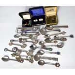 A collection of white metal and plated souvenir spoons for different cities etc, cuff links etc
