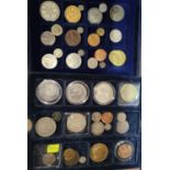 A selection of coins and prize medallions cased