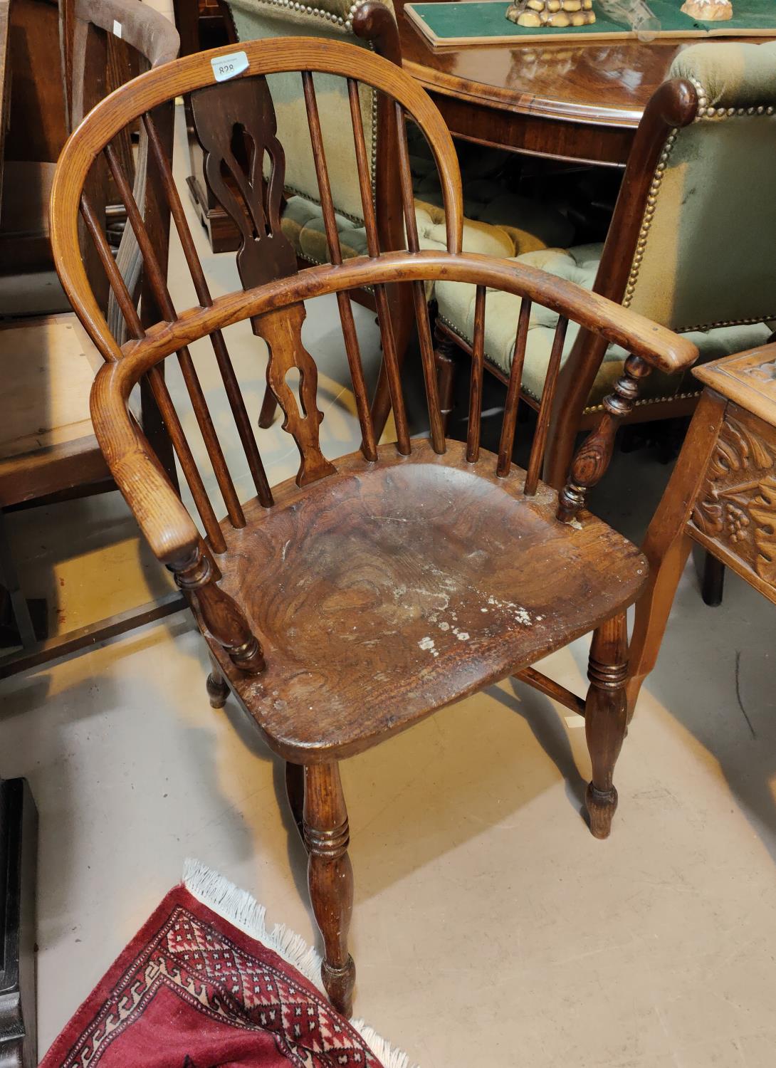 A 19th century ash and elm Windsor armchair with pierced back, solid seat with bowed arms and