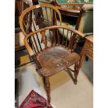 A 19th century ash and elm Windsor armchair with pierced back, solid seat with bowed arms and