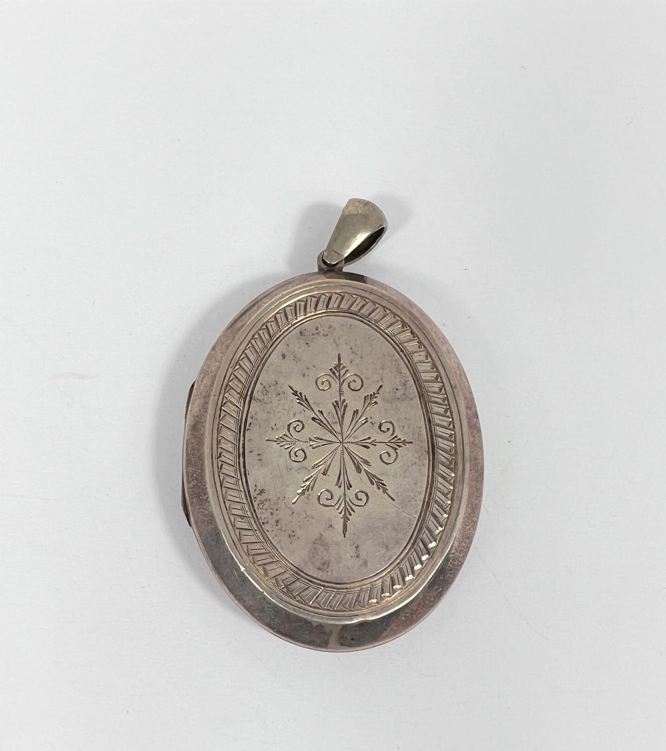 A late 19th century locket with incised decoration to the front and back