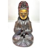 A Chinese bronze:  seated Guan Yin with male child, tracings of original gilding and polychrome to