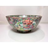 A Chinese famille vert bowl decorated with traditional scenes of figures and flowers, diameter 25.