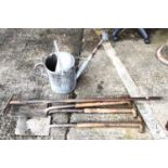 A galvanised steel vintage watering can and a selection of vintage garden tools