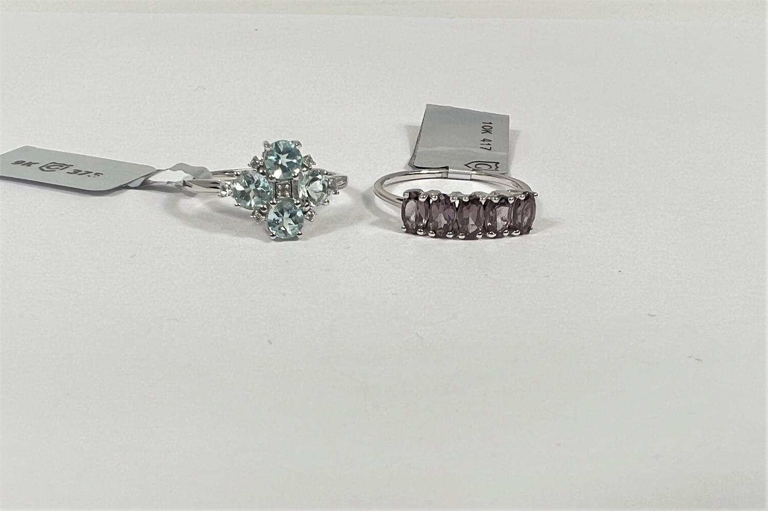 A white gold ring set with Aquaiba Beryl and white zircon stones, size N/O;  a white gold ring