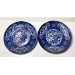 A pair of late 19th/early 20th century Japanese wall plaques with blue and white decoration of