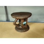 An Ethiopian possibly Jimma or Gurage, wooden stool with carved wooden pillars and a triangular