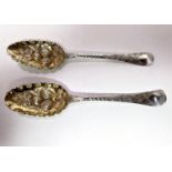 A pair of mid-Georgian embossed and chased hallmarked silver berry spoons. London, date mark