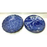 A late 19th/early 20th century Japanese wall plaque in blue and white willow pattern, diameter 30cm;