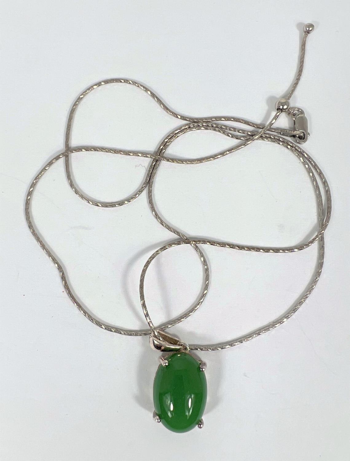 A silver necklace with jade coloured hardstone cabochon