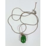 A silver necklace with jade coloured hardstone cabochon