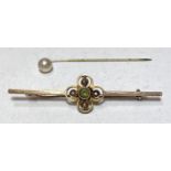 An Edwardian 9 carat gold bar brooch set peridot and seed pearls and a stick pin