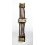 A lady's dress watch by Anne Klein, in gilt metal with 5 strand woven strap and 'lifetime' battery