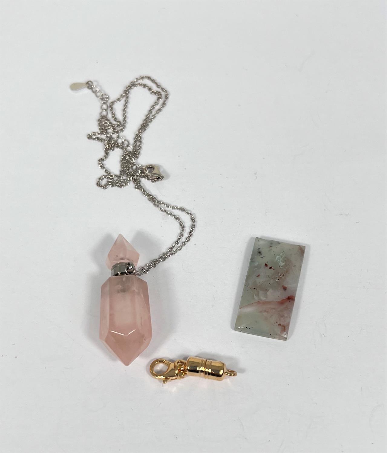 A 21.6 Aquaprase rectangular stone; a pink quartz pendant perfume holder with screw on chain top;