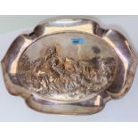 An early 20th century WMF style dish with shaped border, decorated with shepherdess in relief,