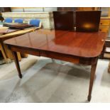 A late 19th/early 20th century rounded rectangular extended dining table, one spare leaf on square