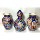 A pair of Imari baluster vases, height 15cm (some rim restoration); an Imari double gourd shaped