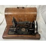 A vintage cased Jappaned metal sewing machine