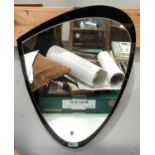 A mid 20th century shaped mirror in black/clear glass