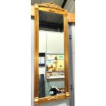 A traditional style wall mirror with hand gilded surround, bevelled glass with shell and column
