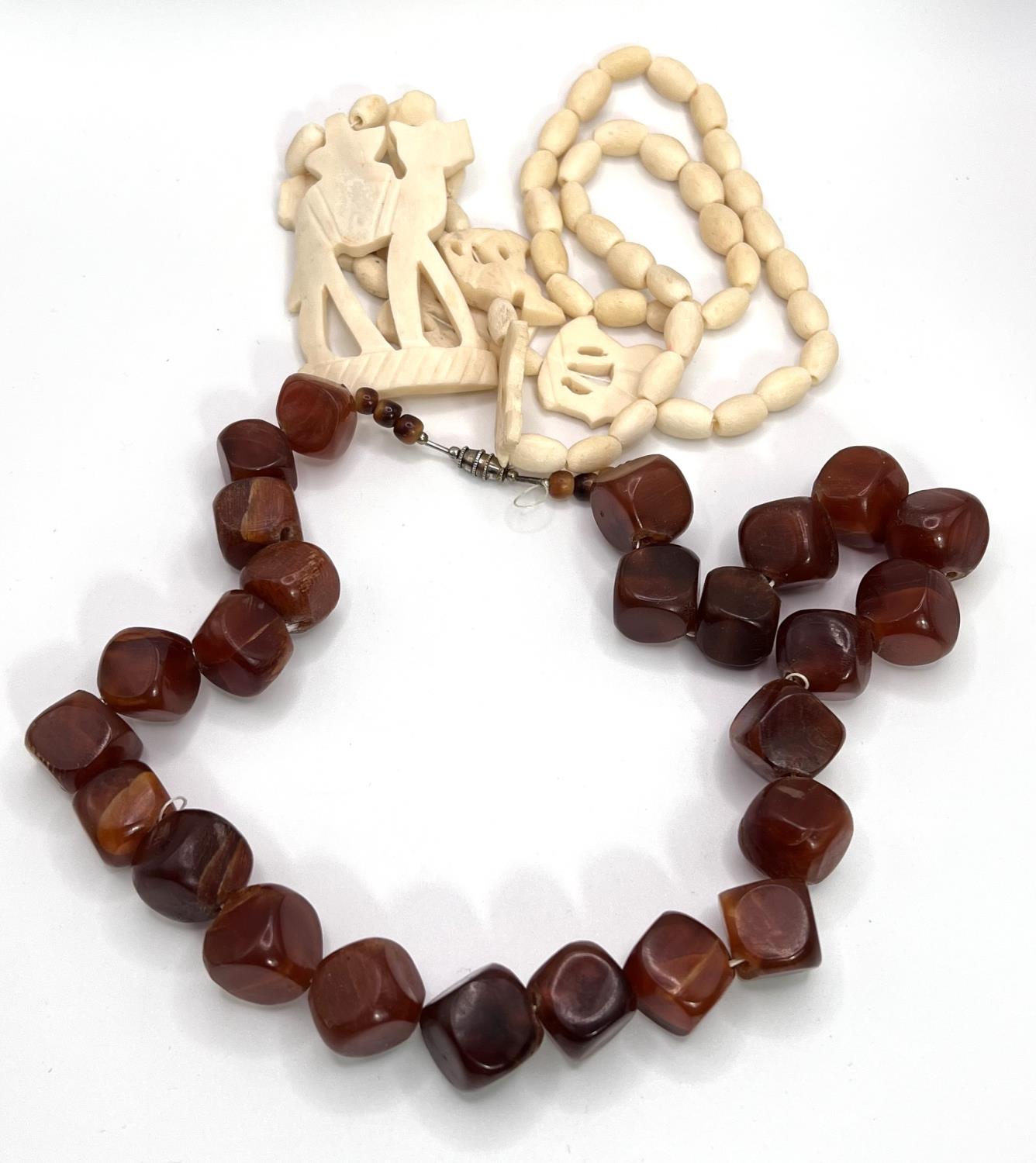 A camel bone necklace; a mid 20th century necklace formed from amber coloured cube shaped beads