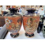 A pair of late 19th century Japanese Satsuma vases, decorated with deities, dragons etc with blue