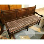 A late 18th/early 19th century North country oak settle with triple raised and fielded panels to the