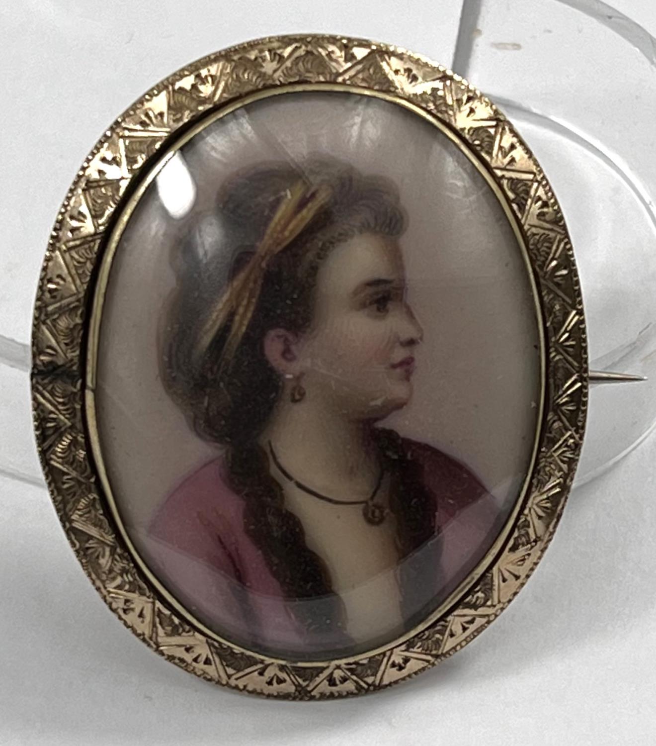 A miniature bust portrait on porcelain brooch of a young lady in 18th century dress in yellow - Image 2 of 3