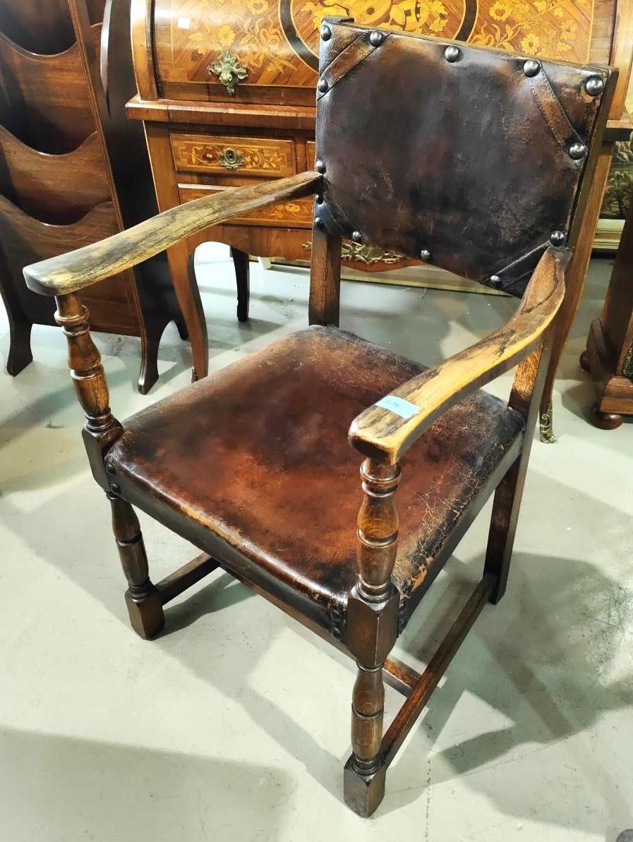 An Oak Cromwellian style studded leather armchair