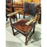 An Oak Cromwellian style studded leather armchair