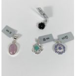 A selection of sterling silver pendant drops to include a circular tanzanite blue sapphire and white