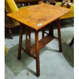 An oak Arts and crafts occasional table with pierced decoration to the uprights, undershelf support,