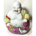 A Chinese Republic period porcelain figure of Ho Tai in seated position, with impressed seal mark to