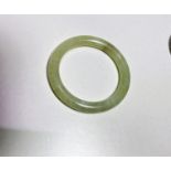 A Chinese Jade coloured hard stone bangle