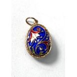 An enamel egg shaped pendant blue ground with floral decoration