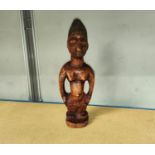 A Yoruba female Ibeji wooden figure with detailed face and blueish hair, height 28cm