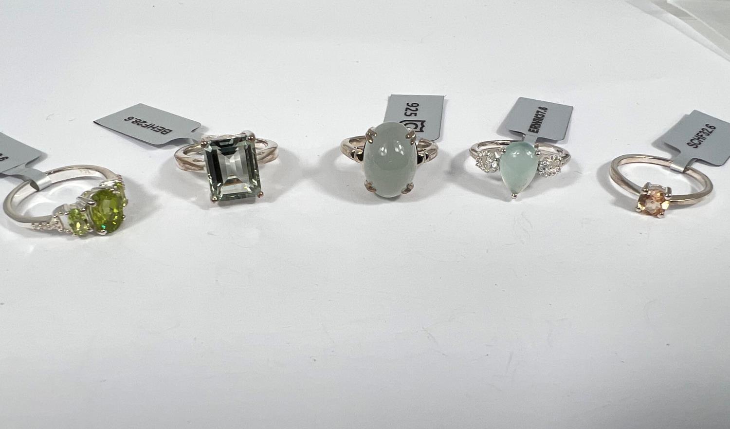 5 sterling silver dress rings to include:- an Imperial garnet; an oval cabochon cloudy aquamarine;