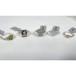 5 sterling silver dress rings to include:- an Imperial garnet; an oval cabochon cloudy aquamarine;