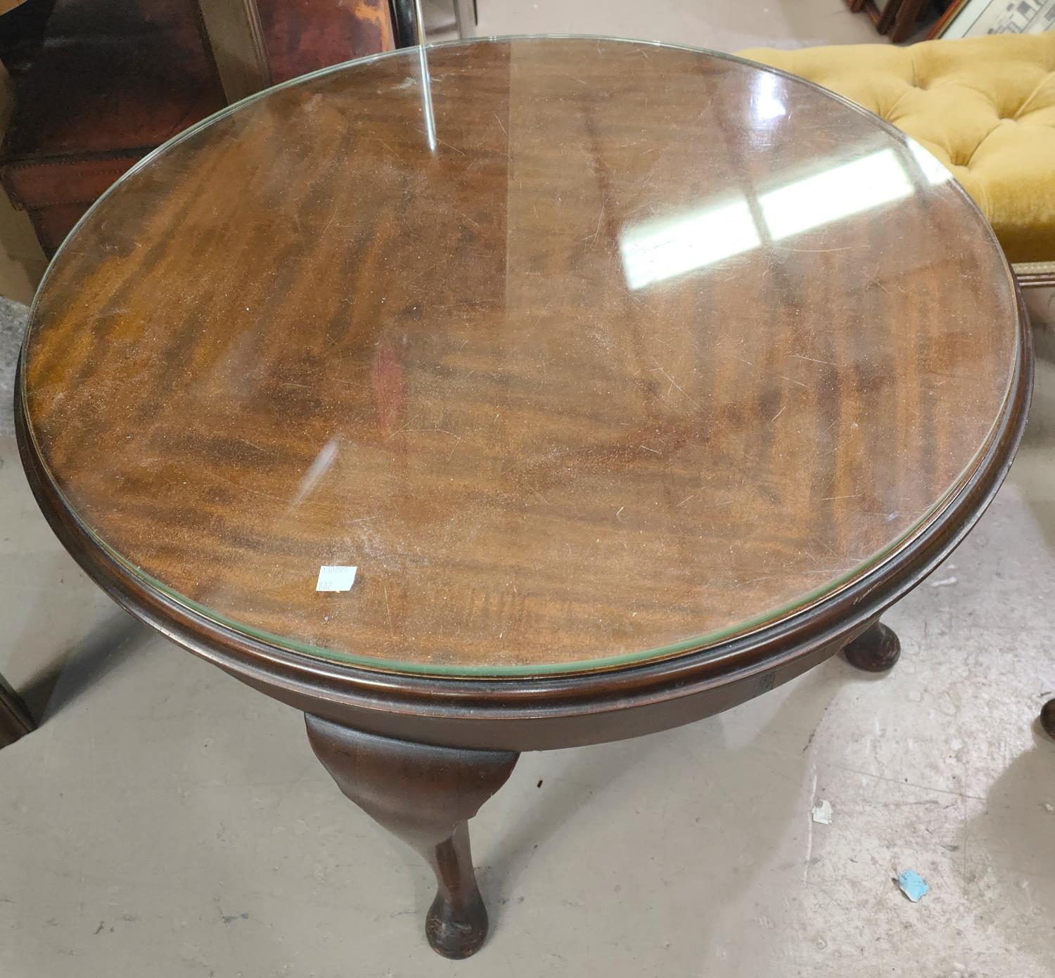 A mahogany circular coffee table; an occasional table/magazine rack; a Victorian footstool; an