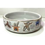 A Chinese Republic period shallow bowl decorated in polychrome with children exercising, orange seal