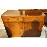 An oak Art Deco sideboard with double fitted drawers and cupboards bellow, length 121cm
