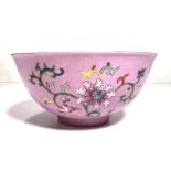 A Chinese famille rose bowl with swirling incised decoration with polychrome flowers and seal mark