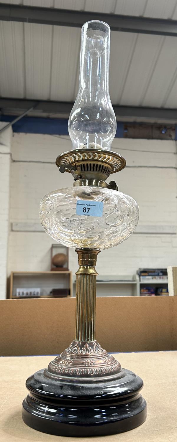 A 19th century Arts & Crafts style oil lamp in copper and brass with bubbled glass reservoir and