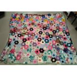 A large vintage patchwork quilt made up of hexagonal pieces in a floral shape, 215x200 cm