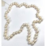 A single strand necklace of 60 pearls, approx, average diameter 10mm, with natural blemishes, length